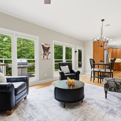 Spacious living area features large windows, modern kitchen amenities, and outdoor access for entertaining.