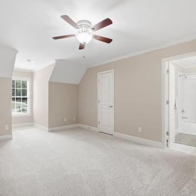 Spacious, multi-functional room featuring plush carpet, natural light, and an en-suite bathroom for convenience.