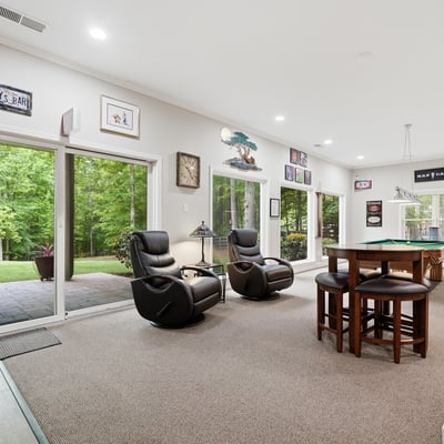 Spacious indoor entertainment area with panoramic views, perfect for gatherings and enjoying nature.