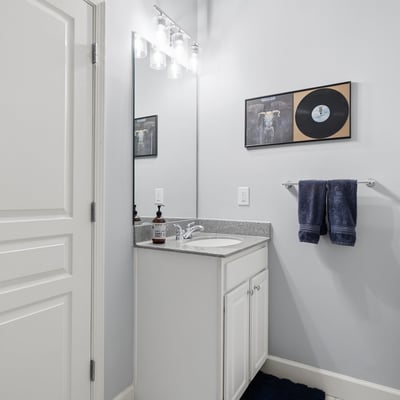 Bright and functional bathroom featuring modern fixtures, a spacious countertop, and contemporary decor.