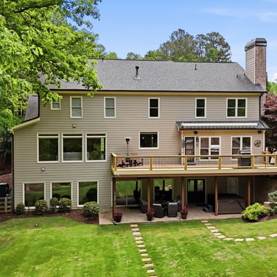 Spacious home with expansive outdoor living and large windows, perfect for enjoying the surrounding nature.