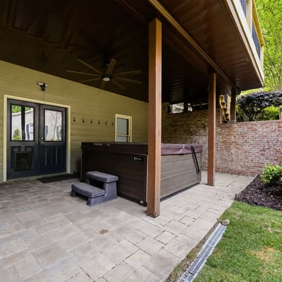 Discover this covered patio featuring a hot tub, perfect for outdoor relaxation and entertaining.