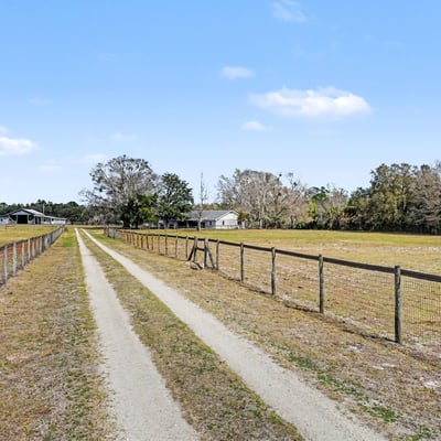 The private driveway boasts a solar-powered gate! Solar powered lighting lights the entry after dark.