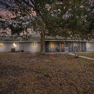 This 3 BR Ranch-style home features an abundance of natural wood and stone accents. Blending country charm with modern convenience, located close to beaches and shopping, this serene 5-acre setting encourages relaxation and creativity.