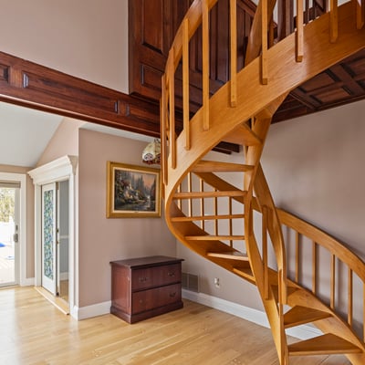Discover a unique spiral staircase that enhances the inviting entryway of this modern home.