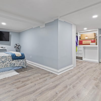 Spacious basement retreat featuring dual TVs, ample storage, and a cozy atmosphere for relaxation.