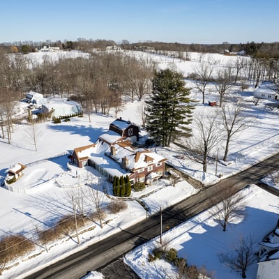 Spacious homes on expansive snowy lots, surrounded by trees and tranquil countryside views, perfect for peaceful living.