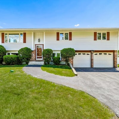 Spacious split-level home with a generous front yard, two-car garage, and ample natural light throughout.