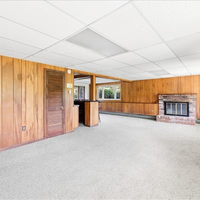 Spacious living area with natural light and cozy fireplace, perfect for creating your ideal retreat.