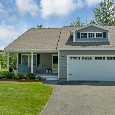 This inviting home features an ample front yard, covered porch, and convenient garage space.
