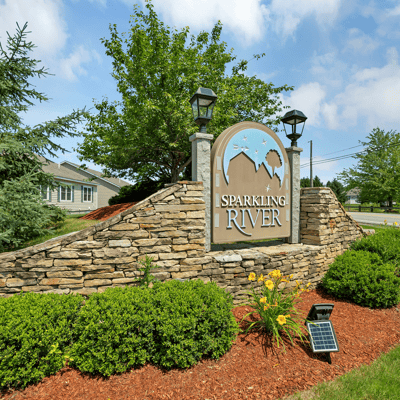 Discover the inviting entrance of Sparkling River, featuring beautiful landscaping and a welcoming community vibe.