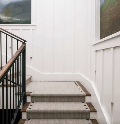 Stylish staircase featuring elegant wood accents and contemporary artwork, perfect for enhancing your home's aesthetic.