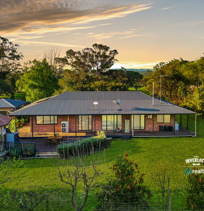 Spacious home set on lush grounds, featuring expansive outdoor areas and stunning views of the landscape.