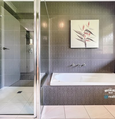 Spacious bathroom featuring a double vanity, modern shower, and relaxing bathtub for ultimate comfort.
