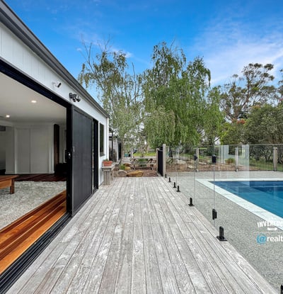 Modern home featuring open spaces, seamless indoor-outdoor flow, and a refreshing pool set amidst nature.