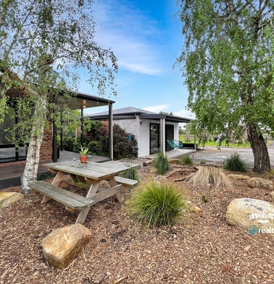 Discover a unique outdoor space featuring a picnic area surrounded by natural landscaping and modern amenities.