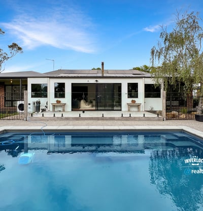 Contemporary home featuring a spacious poolside area, ideal for outdoor entertaining and relaxation.