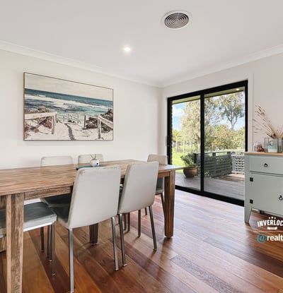 Bright dining area featuring large windows, showcasing views of the outdoors and modern design elements.