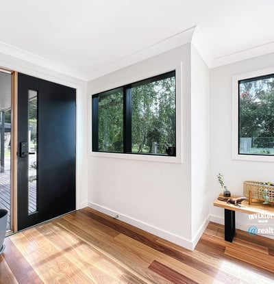 Bright entryway featuring large windows and natural light, welcoming you into a spacious home.