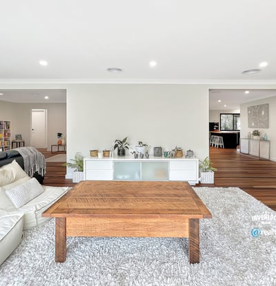 Spacious living area with modern design, featuring abundant light and seamless flow to adjacent rooms.