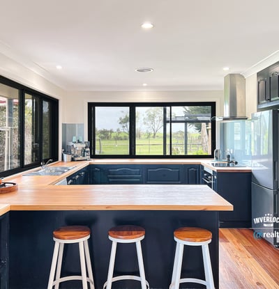 Modern kitchen featuring sleek cabinetry, expansive windows with scenic views, and a spacious island for entertaining.