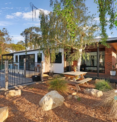 Discover this modern home featuring an inviting outdoor space, pool, and beautiful landscaping for relaxed living.