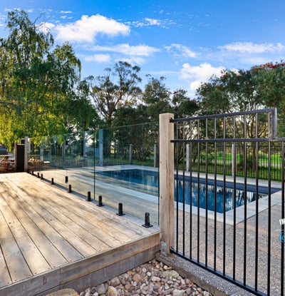 Discover a modern outdoor retreat featuring a pristine pool and expansive nature views, perfect for relaxation.