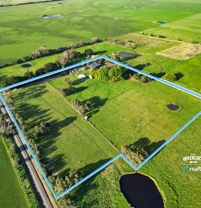 Spacious rural property featuring open fields, ponds, and mature trees, offering endless possibilities for development.