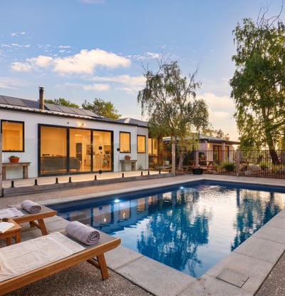 This modern home features a private pool and spacious outdoor area, perfect for entertaining and relaxation.