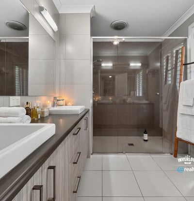 Modern bathroom featuring spacious shower, dual vanities, and clean lines, perfect for daily relaxation.