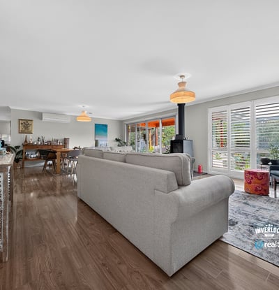 Spacious open-concept living area with abundant natural light, featuring modern decor and inviting spaces for gatherings.