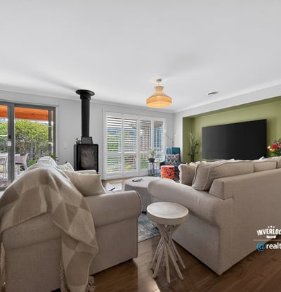 Bright living space featuring a cozy fireplace, modern decor, and seamless access to an outdoor area.