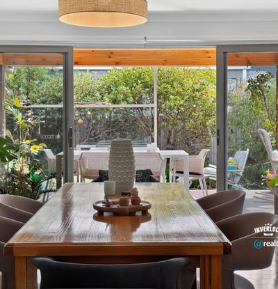 Bright dining area seamlessly connects to a spacious outdoor patio, perfect for entertaining and relaxing.