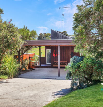 Discover this unique home surrounded by vibrant greenery, offering a seamless blend of indoor and outdoor living.