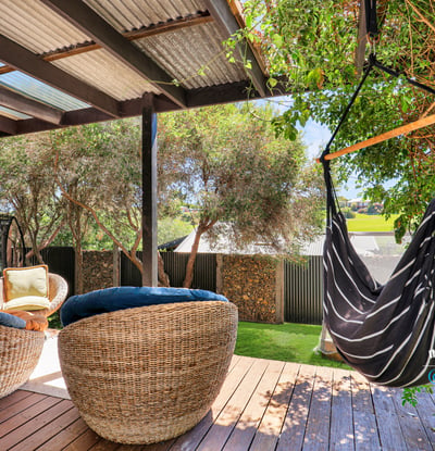 Inviting outdoor space with comfortable seating and a hammock, perfect for relaxation and entertaining.