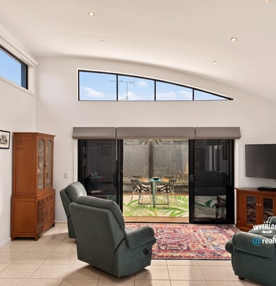 Bright living area featuring large windows, access to the outdoor space, and modern amenities for comfort.