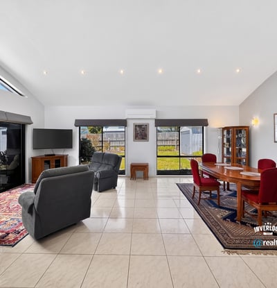 Spacious living area featuring abundant natural light, ideal for both relaxation and entertaining.