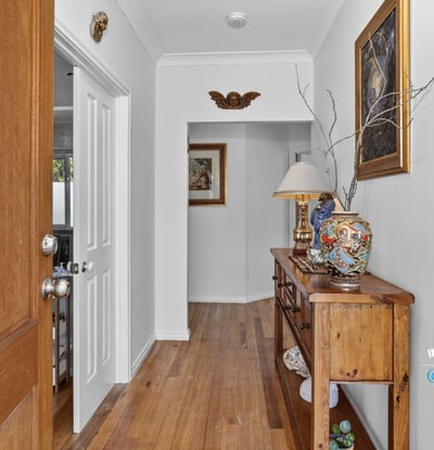 Welcoming entryway featuring warm wooden accents, unique decor, and a cozy atmosphere for guests.