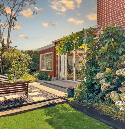 Discover this inviting outdoor space, featuring lush landscaping and a cozy seating area for relaxation.