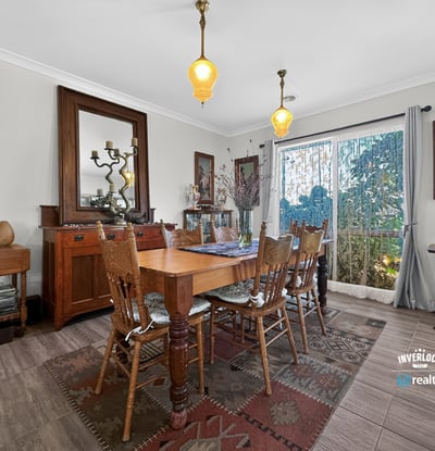 Discover a warm dining area featuring natural light, vintage decor, and inviting outdoor views.