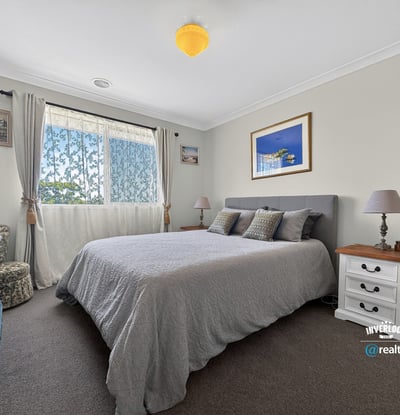Spacious bedroom featuring natural light, cozy furnishings, and a tranquil atmosphere ideal for relaxation.