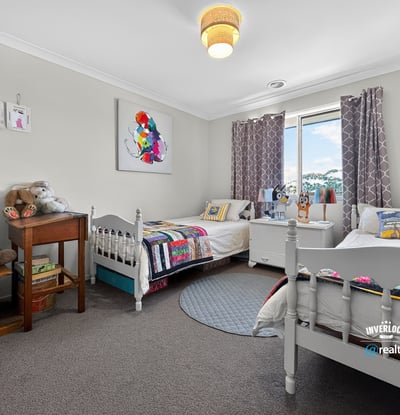 Bright and inviting bedroom featuring cozy beds, playful decor, and ample natural light. Perfect for creativity!