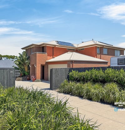 This spacious two-story home features modern amenities, ample parking, and well-maintained landscaping in a prime location.
