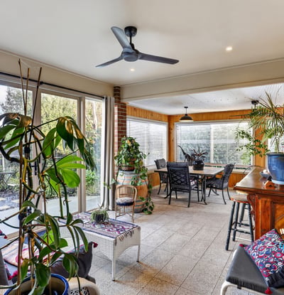 Bright and spacious sunroom featuring ample natural light, perfect for relaxing and entertaining.