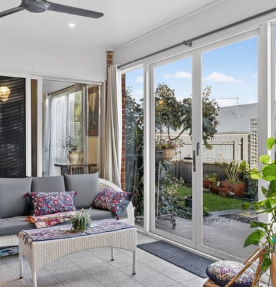 Bright and airy sunroom featuring large windows, perfect for relaxation and enjoying views of the garden.