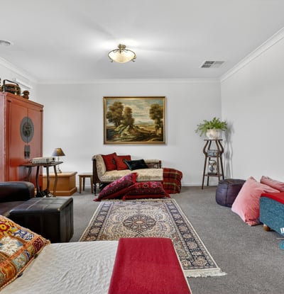 Spacious living area featuring diverse seating options and artwork, perfect for relaxation and gatherings.