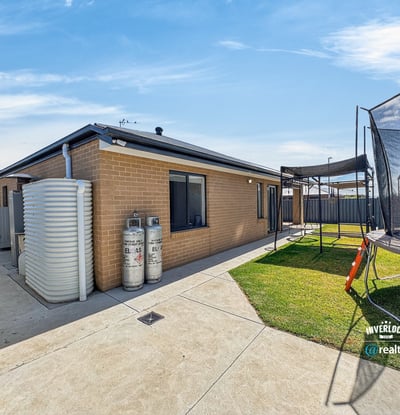 Modern home featuring spacious outdoor area with trampoline, perfect for family gatherings and playtime.