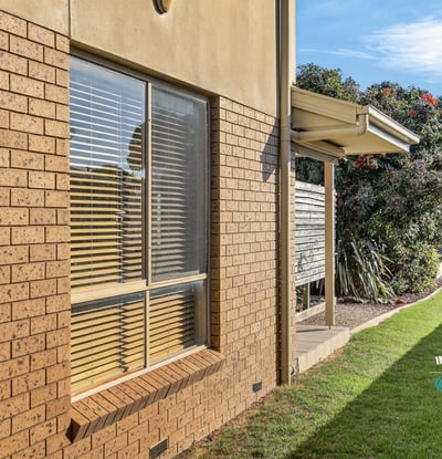 Spacious outdoor area with well-maintained landscaping and ample natural light streaming through large windows.