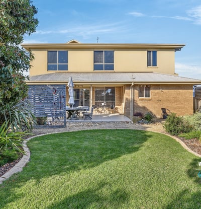 This spacious two-story home features a landscaped yard, perfect for outdoor gatherings and relaxation.
