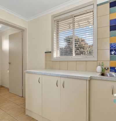 Bright and functional kitchen space featuring colorful backsplash tiles and ample storage options.